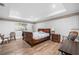 Cozy bedroom with hardwood floors and comfortable bed and natural light at 1904 Rosewood Ln, Woodstock, GA 30189