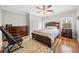 Bedroom with hardwood floors, a ceiling fan, large wood furniture, and neutral walls at 1904 Rosewood Ln, Woodstock, GA 30189