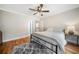 Bedroom features hardwood floors, neutral walls, ceiling fan, and an area rug at 1904 Rosewood Ln, Woodstock, GA 30189