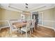 Stylish dining room featuring hardwood floors, a chandelier, and easy access to other living spaces at 1904 Rosewood Ln, Woodstock, GA 30189