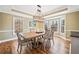 Elegant dining room with a decorative chandelier, wainscoting, and large windows offering natural light at 1904 Rosewood Ln, Woodstock, GA 30189