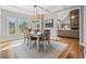 Dining room with a table that seats six, large windows and a view into the living area at 1904 Rosewood Ln, Woodstock, GA 30189