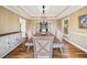 Spacious dining room featuring a tray ceiling, hardwood floors, and an adjacent buffet for added storage at 1904 Rosewood Ln, Woodstock, GA 30189