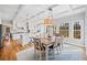 Open dining area with a table for six, hardwood floors, and views into the bright kitchen at 1904 Rosewood Ln, Woodstock, GA 30189