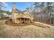 Exterior of home featuring deck, lower-level patio, and landscaped backyard at 1904 Rosewood Ln, Woodstock, GA 30189