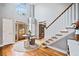 Bright and airy foyer with hardwood floors, a staircase, a round table with decor, and a view of the front door at 1904 Rosewood Ln, Woodstock, GA 30189