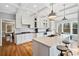 Bright kitchen with white cabinets, granite countertops, stainless steel appliances, and hardwood floors at 1904 Rosewood Ln, Woodstock, GA 30189