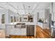 Modern kitchen with a stainless steel farmhouse sink, white cabinetry and hardwood floors at 1904 Rosewood Ln, Woodstock, GA 30189