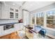 Cozy kitchenette with white cabinetry, stainless steel oven, and a small table with bench seating at 1904 Rosewood Ln, Woodstock, GA 30189