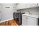 Well-equipped laundry room with modern washer, dryer, sink, and storage cabinets for efficient organization at 1904 Rosewood Ln, Woodstock, GA 30189