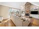 Inviting living room with a stone fireplace, hardwood floors, and large windows for ample natural light at 1904 Rosewood Ln, Woodstock, GA 30189