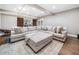 Cozy living room with a large sectional sofa, ottoman, and hardwood floors at 1904 Rosewood Ln, Woodstock, GA 30189