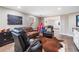 Relaxing living room with a leather sofa, armchair, and a play tent in the background at 1904 Rosewood Ln, Woodstock, GA 30189