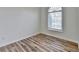 Empty bedroom featuring hardwood flooring and arched window for a bright and airy feel at 3535 Southmont Ct, Cumming, GA 30041