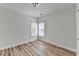 An empty bedroom featuring two windows, hardwood flooring and white walls at 3535 Southmont Ct, Cumming, GA 30041