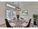 Bright dining area featuring a modern table, designer lighting and large window at 3535 Southmont Ct, Cumming, GA 30041