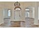 Elegant foyer with hardwood floors, arched doorways and modern chandelier at 3535 Southmont Ct, Cumming, GA 30041