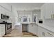 Bright kitchen featuring stainless steel appliances, white cabinets and quartz countertops at 3535 Southmont Ct, Cumming, GA 30041