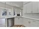 Kitchen with stainless appliances, white cabinets, and a view of the breakfast nook at 3535 Southmont Ct, Cumming, GA 30041