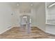 Spacious living room featuring wood floors and lots of natural light from the entry door at 3535 Southmont Ct, Cumming, GA 30041