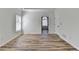 A minimal bright room with hardwood floors and a doorway to an adjacent space at 3535 Southmont Ct, Cumming, GA 30041