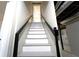 Basement stairs with white steps and a black handrail, leading to a finished area at 610 Walnut Sw Pl, Marietta, GA 30060