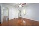 Spacious bedroom featuring hardwood floors, a ceiling fan, two windows, and ample closet space at 610 Walnut Sw Pl, Marietta, GA 30060