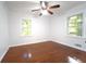 Bedroom with hardwood floors, two windows, a ceiling fan and neutral colored walls at 610 Walnut Sw Pl, Marietta, GA 30060