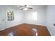 Bedroom with hardwood floors, two windows, a ceiling fan and neutral colored walls at 610 Walnut Sw Pl, Marietta, GA 30060