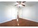 Bedroom featuring hardwood floors, a ceiling fan, two windows, and neutral colored walls at 610 Walnut Sw Pl, Marietta, GA 30060