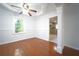 Bright dining room featuring a ceiling fan, hardwood floors, and large windows at 610 Walnut Sw Pl, Marietta, GA 30060