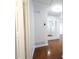 Hallway with hardwood floors, white trim, and a mirrored wall decor at 610 Walnut Sw Pl, Marietta, GA 30060