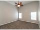 Bedroom with carpet floors, fan and light, with natural light from two windows at 6251 Lamp Post Pl, Atlanta, GA 30349