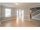 Bright living room showcasing hardwood floors, crown molding, and ample natural light at 6251 Lamp Post Pl, Atlanta, GA 30349