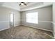 Comfortable bedroom featuring tray ceilings, neutral walls, and plush carpet at 6251 Lamp Post Pl, Atlanta, GA 30349