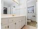 Bright bathroom featuring a white vanity, gold fixtures and a separate toilet room at 334 Nancy Sw Ct, Lilburn, GA 30047