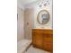 Updated bathroom featuring a tile shower and a vanity with decorative mirror at 334 Nancy Sw Ct, Lilburn, GA 30047