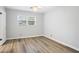 A minimalist bedroom with light gray walls and modern laminate flooring at 334 Nancy Sw Ct, Lilburn, GA 30047