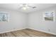 A minimalist bedroom with light gray walls and modern laminate flooring at 334 Nancy Sw Ct, Lilburn, GA 30047