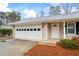 Attached two car garage with white door and mulched landscaping leading to the front door entrance at 334 Nancy Sw Ct, Lilburn, GA 30047