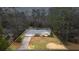 Aerial shot of a cozy one-story home with outlined property lines, surrounded by mature trees at 334 Nancy Sw Ct, Lilburn, GA 30047