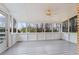 A sunroom featuring a fan and many windows with a view of the treeline at 334 Nancy Sw Ct, Lilburn, GA 30047