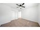 Neutral carpeted bedroom with a ceiling fan and a closet, offering a cozy and functional space at 801 N Evelyn Nw, Atlanta, GA 30318