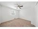 Bright bedroom featuring neutral carpet, a ceiling fan, and a window providing natural light at 801 N Evelyn Nw, Atlanta, GA 30318