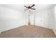 Bright bedroom with neutral carpet, a ceiling fan, closet, and an open door leading to another room at 801 N Evelyn Nw, Atlanta, GA 30318