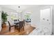 Well-lit dining area with a view to the living room, and hardwood floors at 801 N Evelyn Nw, Atlanta, GA 30318