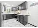 This kitchen features gray cabinets, white marble flooring, stainless appliances and a white door at 801 N Evelyn Nw, Atlanta, GA 30318