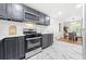 Updated kitchen featuring stainless appliances, gray cabinets, white backsplash and marble-patterned flooring at 801 N Evelyn Nw, Atlanta, GA 30318