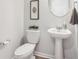 Clean, well-lit bathroom with a pedestal sink, framed art, and modern fixtures at 11837 Rizvan Pl, Covington, GA 30014