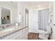 Bathroom featuring granite counters, and a view into another bathroom with toilet and shower at 11837 Rizvan Pl, Covington, GA 30014